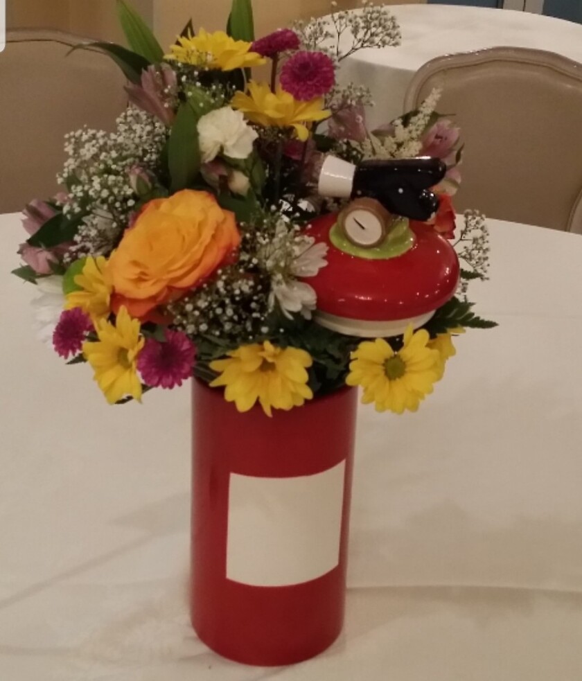 Fire Extinguisher Centerpiece Cookie jar arranged by a florist in
